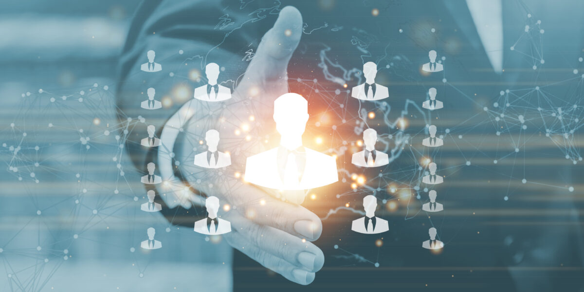 Connected business operations through a central system Business professional interacting with a digital network of connected people icons, representing centralized control and connected operations